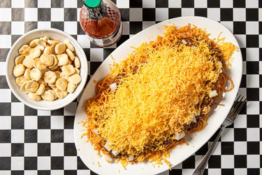 Overhead view of cincinnati chili on a black and white checkered background