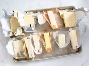 A sheet tray packed with bars of unsalted butter.