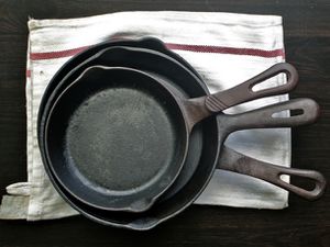Three Cast Iron Skillets stacked inside each other.